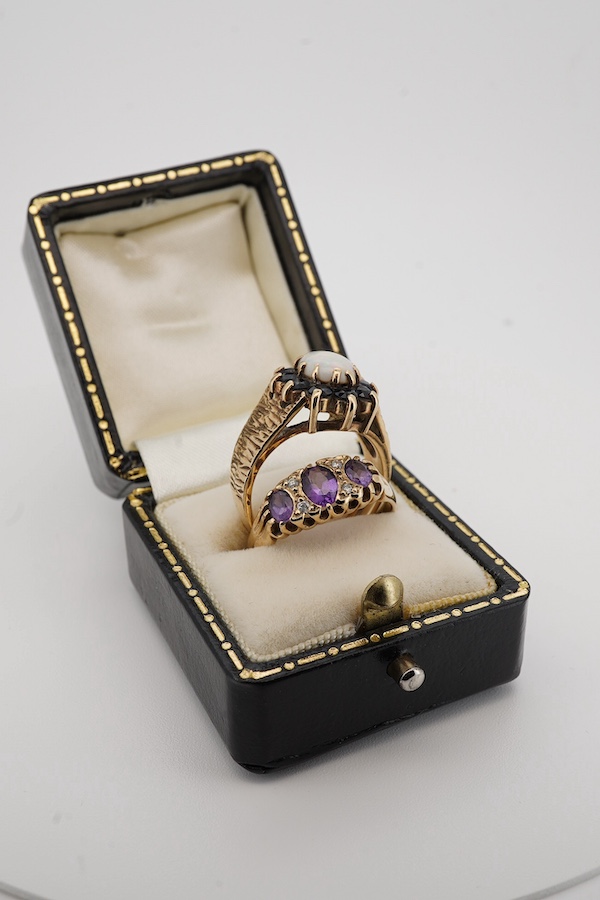 A 1970's textured 9ct gold, white opal and sapphire set oval cluster ring, size L, together with a modern 9ct gold and three stone amethyst set ring, with diamond chip spacers, size M/N, gross weight 7 grams. Condition -